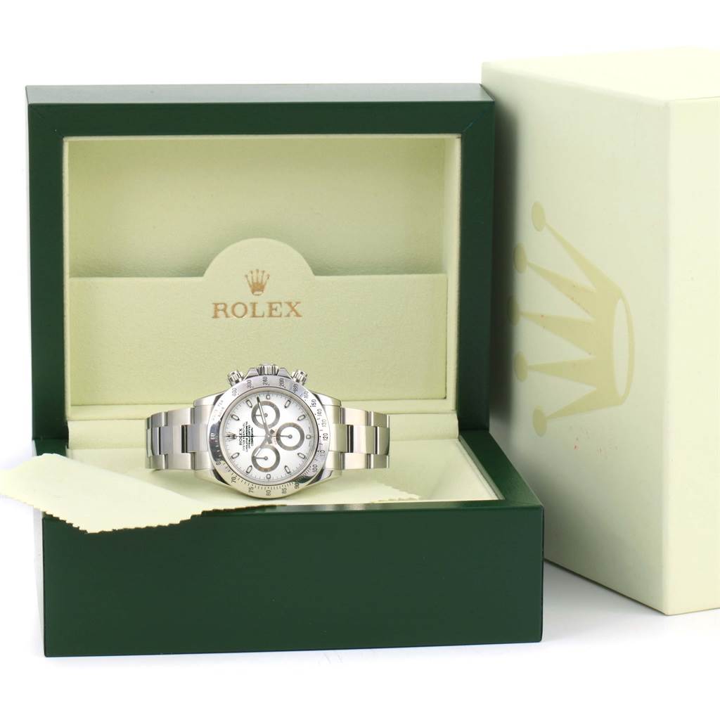 The Rolex Daytona 116520 Men's Stainless Steel White Dial 116520 Men's Stainless Steel White Dial watch is displayed in an open green and cream box, showing the face, band, and side buttons.