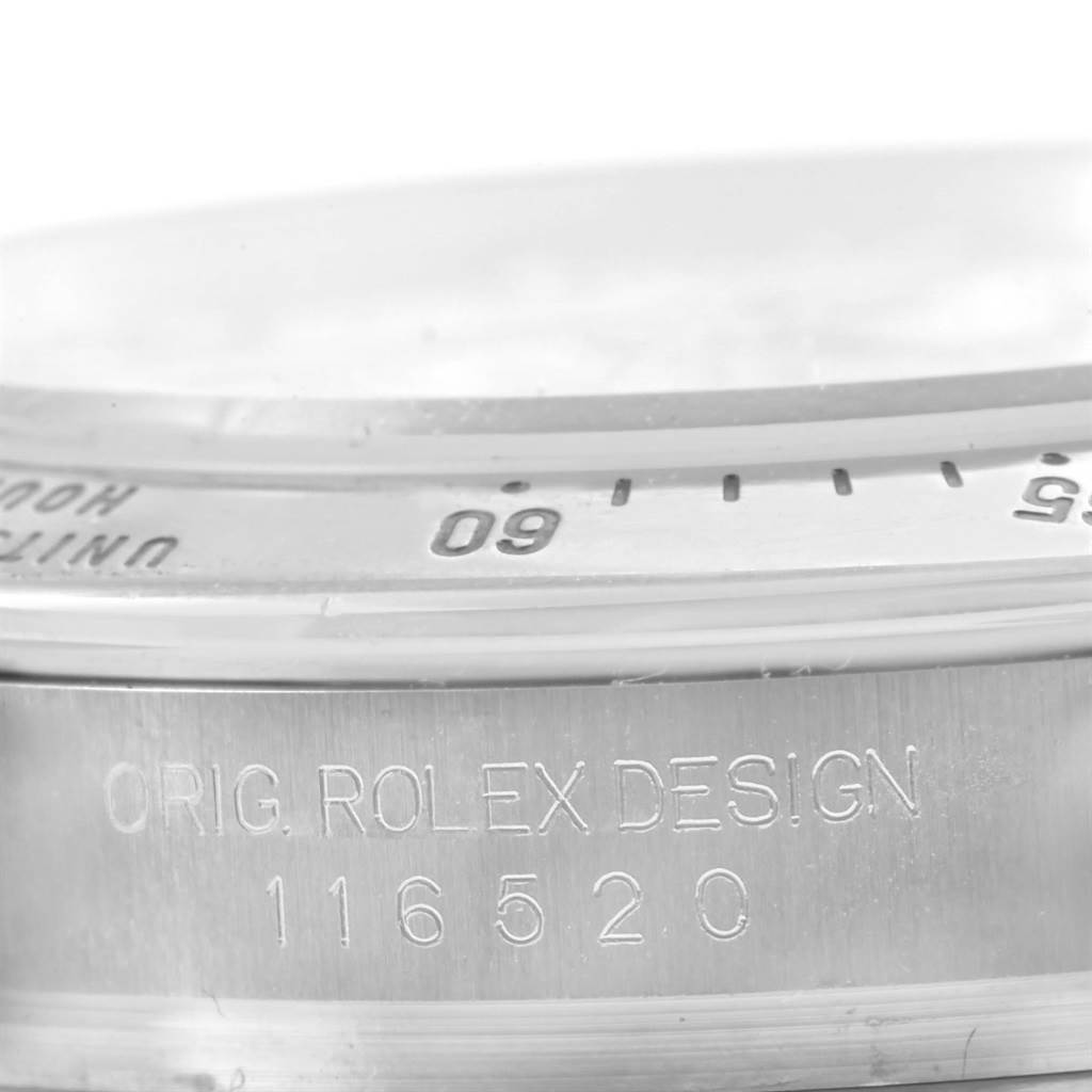 The image shows a close-up angle of the engraved markings and partial bezel of a Rolex Daytona 116520 Men's Stainless Steel White Dial 116520 Men's Stainless Steel White Dial watch.