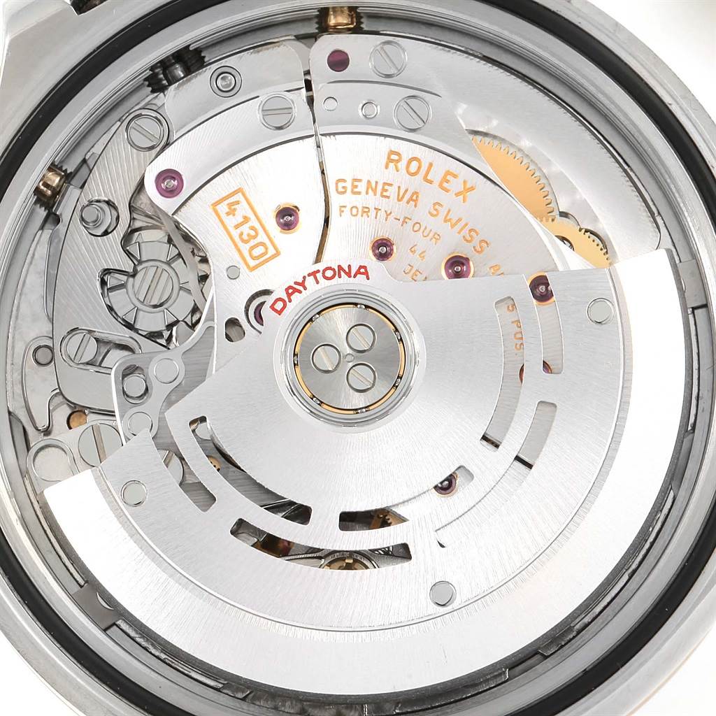 The image shows an up-close view of the Rolex Daytona 116523 Men's Steel and Gold (two tone) Black Dial 116523 Men's Steel and Gold (two tone) Black Dial watch's movement, highlighting intricate internal mechanisms and engravings.