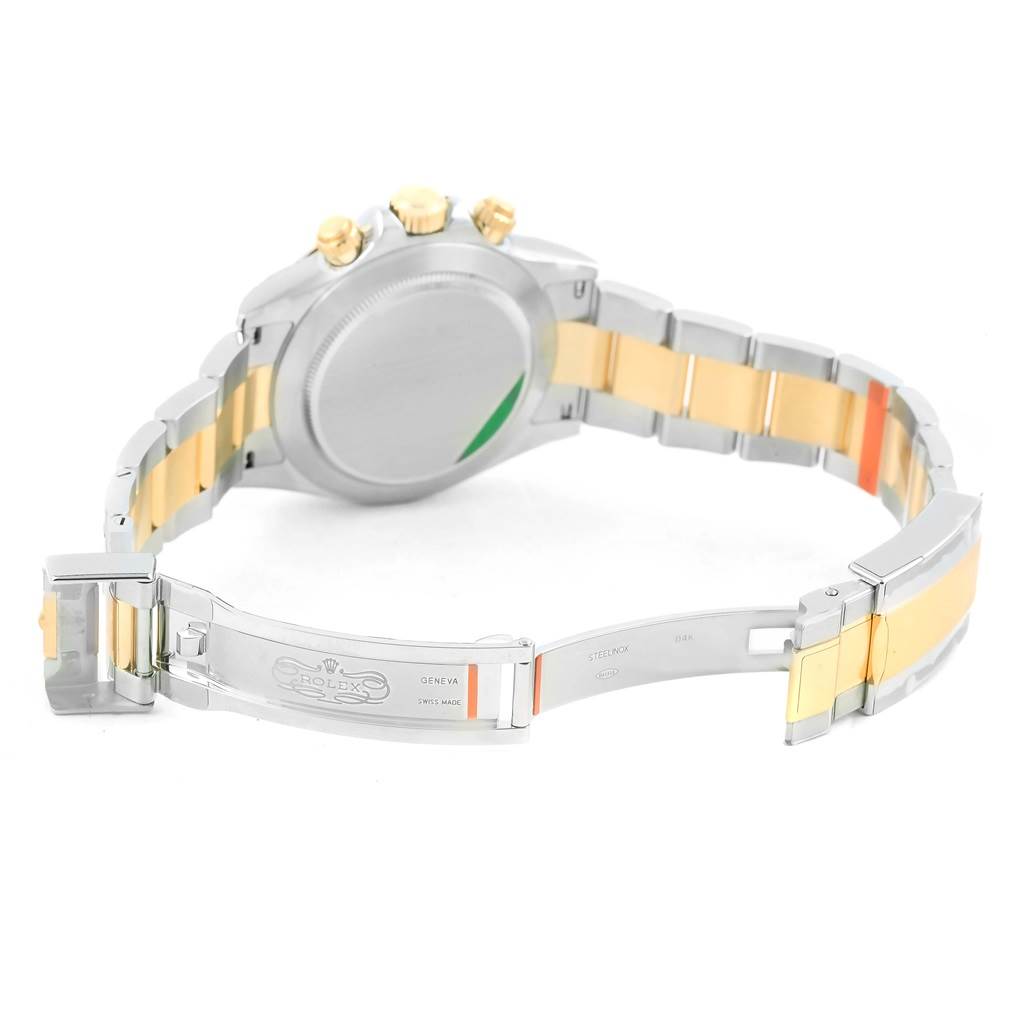 This image shows the back and open clasp of a Rolex Daytona 116503 Men's Steel and Gold (two tone) White Dial 116503 Men's Steel and Gold (two tone) White Dial watch, highlighting its two-tone metal bracelet.