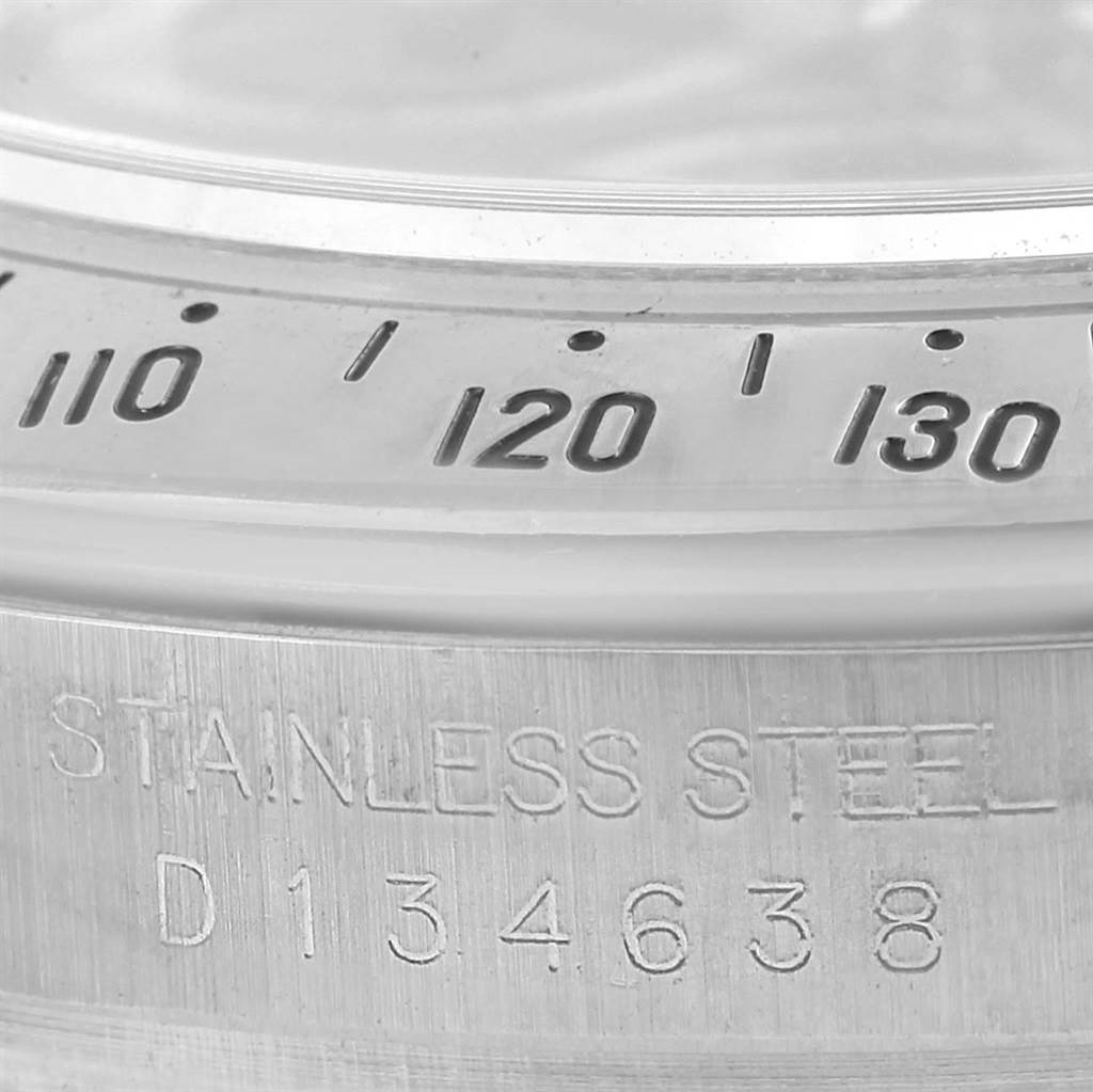 The image shows a close-up of the Rolex Daytona 116520 Men's Stainless Steel Black Dial 116520 Men's Stainless Steel Black Dial watch bezel and the engraved serial number on the rim.