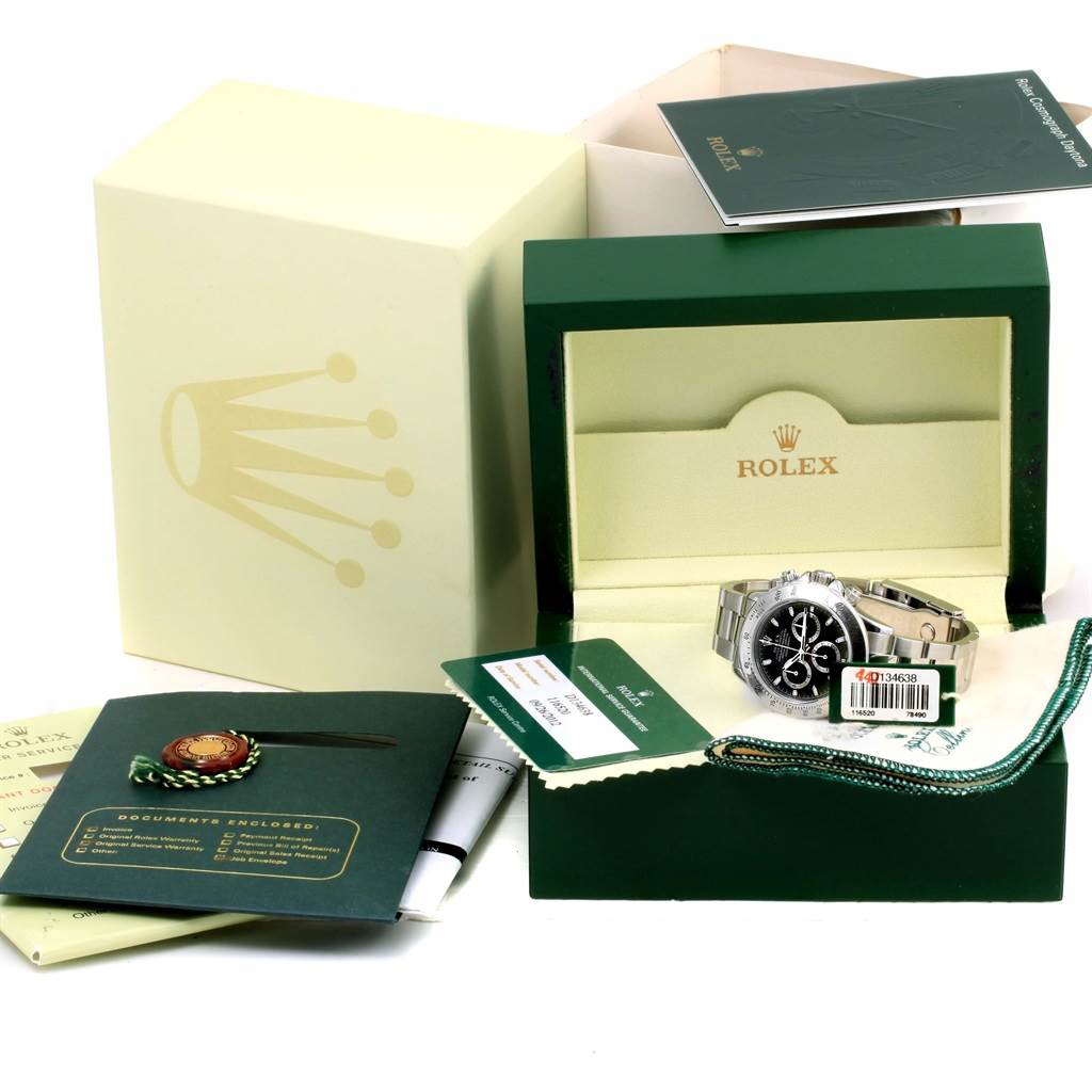 The image shows a Rolex Daytona 116520 Men's Stainless Steel Black Dial 116520 Men's Stainless Steel Black Dial watch with its box, warranty card, manuals, and tags.