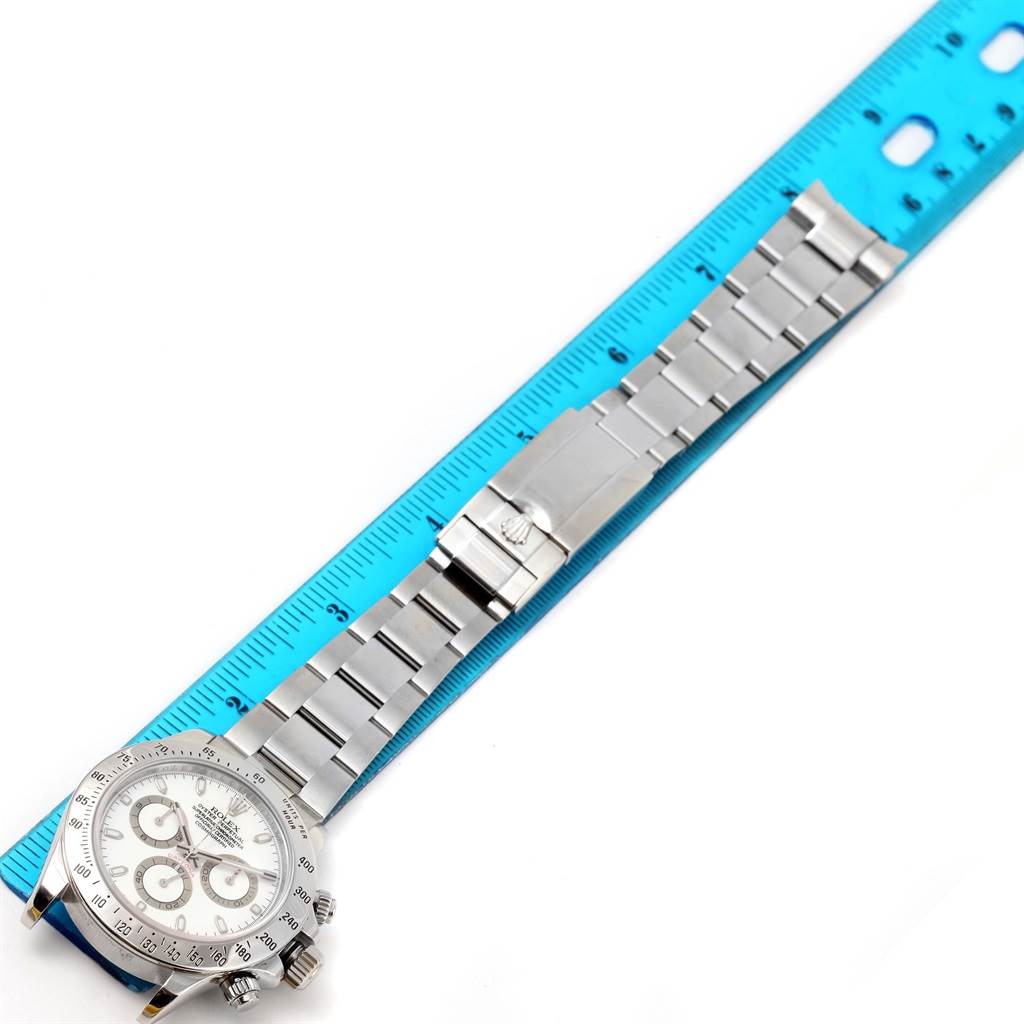 The image shows a Rolex Daytona 116520 Men's Stainless Steel White Dial 116520 Men's Stainless Steel White Dial watch laid flat with a ruler next to it, capturing the full bracelet and watch face.