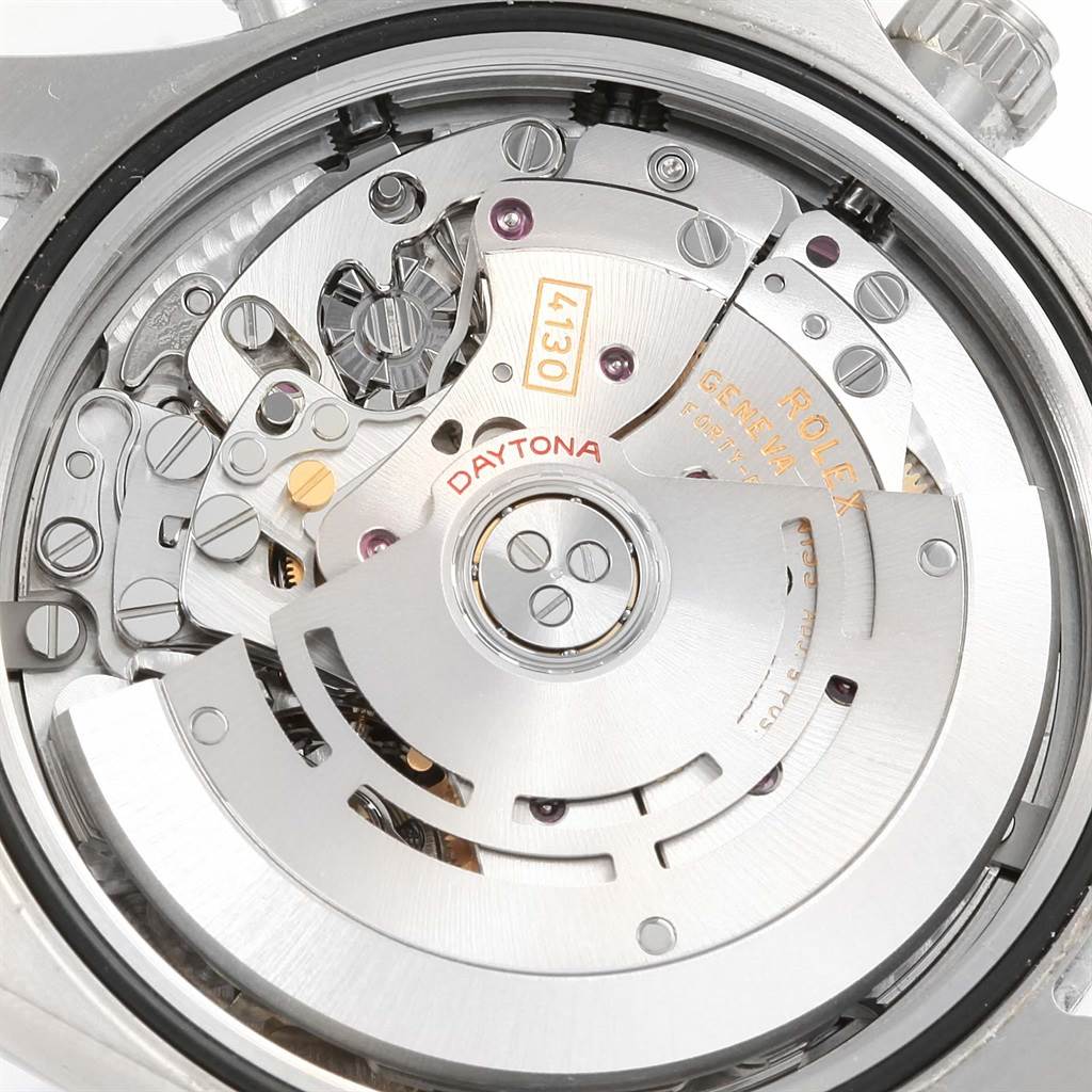 The image shows the intricate inner mechanism of a Rolex Daytona 116520 Men's Stainless Steel White Dial 116520 Men's Stainless Steel White Dial watch at a macro angle, highlighting the movement and rotor.