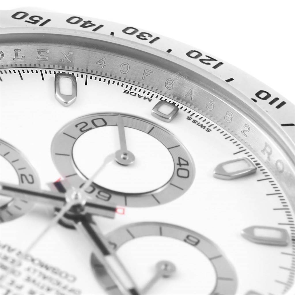 This close-up angle of the Rolex Daytona 116520 Men's Stainless Steel White Dial 116520 Men's Stainless Steel White Dial watch shows the bezel, tachymeter scale, subdials, and part of the face and hands.
