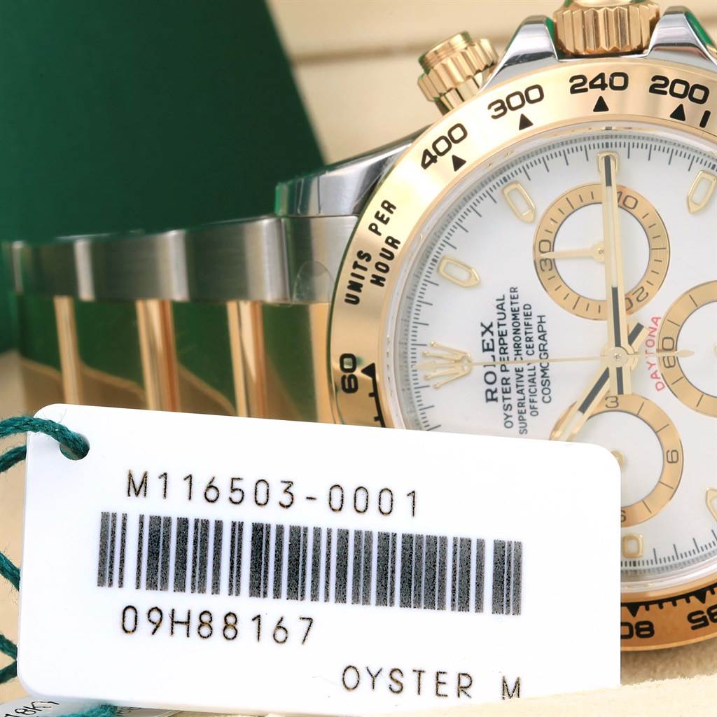 The image shows a partial side-view of a Rolex Daytona 116503 Men's Steel and Gold (two tone) White Dial 116503 Men's Steel and Gold (two tone) White Dial watch highlighting its bezel, dial, and band, along with a tag displaying its model number.