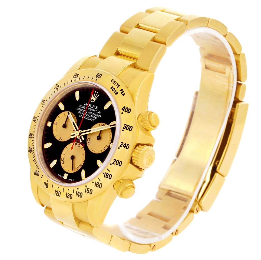 This Rolex Daytona 116528 Men's Yellow Gold Black Dial 116528 Men's Yellow Gold Black Dial watch is shown at an angle, displaying its yellow gold case, bracelet, bezel, and chronograph sub-dials.