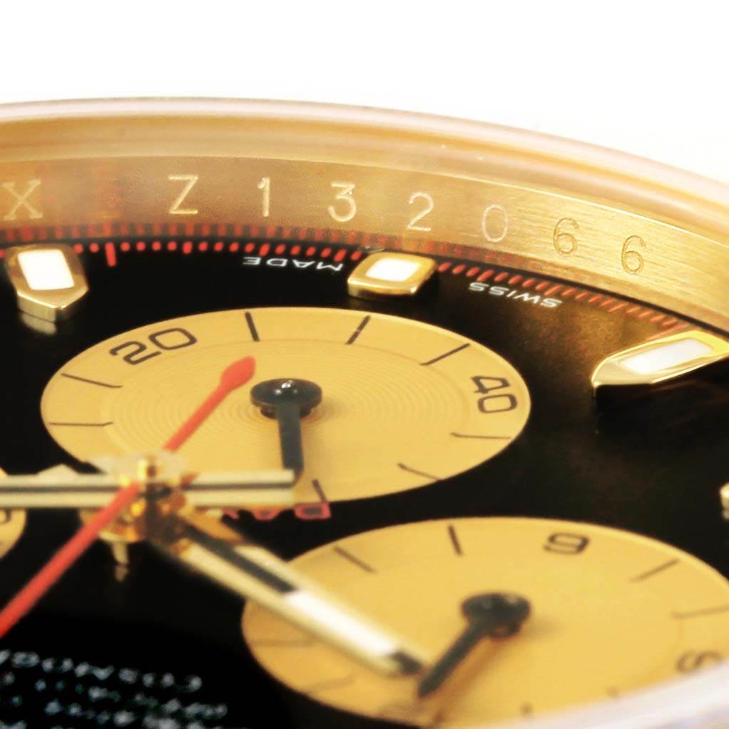 This close-up angle of a Rolex Daytona 116528 Men's Yellow Gold Black Dial 116528 Men's Yellow Gold Black Dial watch shows the sub-dials, hands, and part of the tachymeter scale.