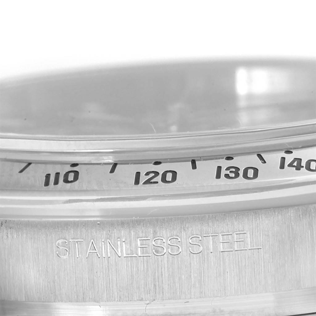 This close-up image of a Rolex Daytona 116520 Men's Stainless Steel Black Dial 116520 Men's Stainless Steel Black Dial watch shows the stainless steel case and part of the bezel with tachymeter markings.