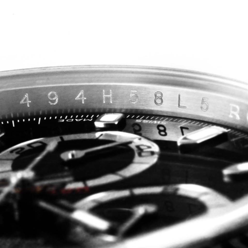 This image shows a close-up angle of the dial and engraved inner bezel of a Rolex Daytona 116520 Men's Stainless Steel Black Dial 116520 Men's Stainless Steel Black Dial watch.