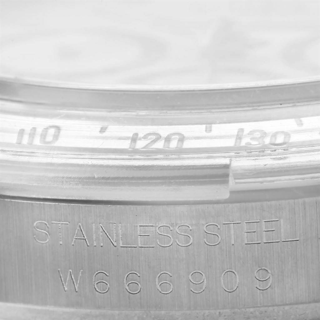 The image shows a close-up of the bezel and serial number on the stainless steel Rolex Daytona 16520 Men
s Stainless Steel White Dial 16520 Men
s Stainless Steel White Dial watch.