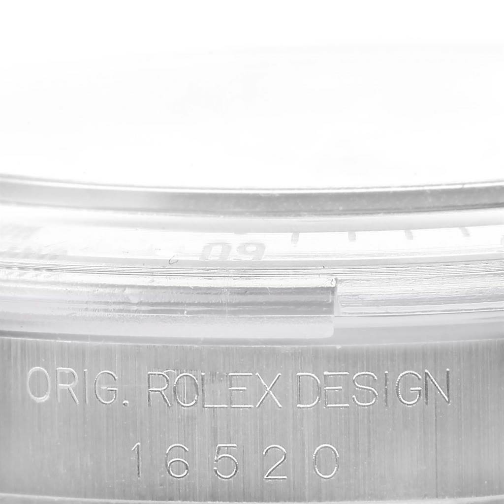 This image shows a close-up of the side of a Rolex Daytona 16520 Men
s Stainless Steel White Dial 16520 Men
s Stainless Steel White Dial watch, highlighting the engraved model number "16520" and "ORIG. ROLEX DESIGN."