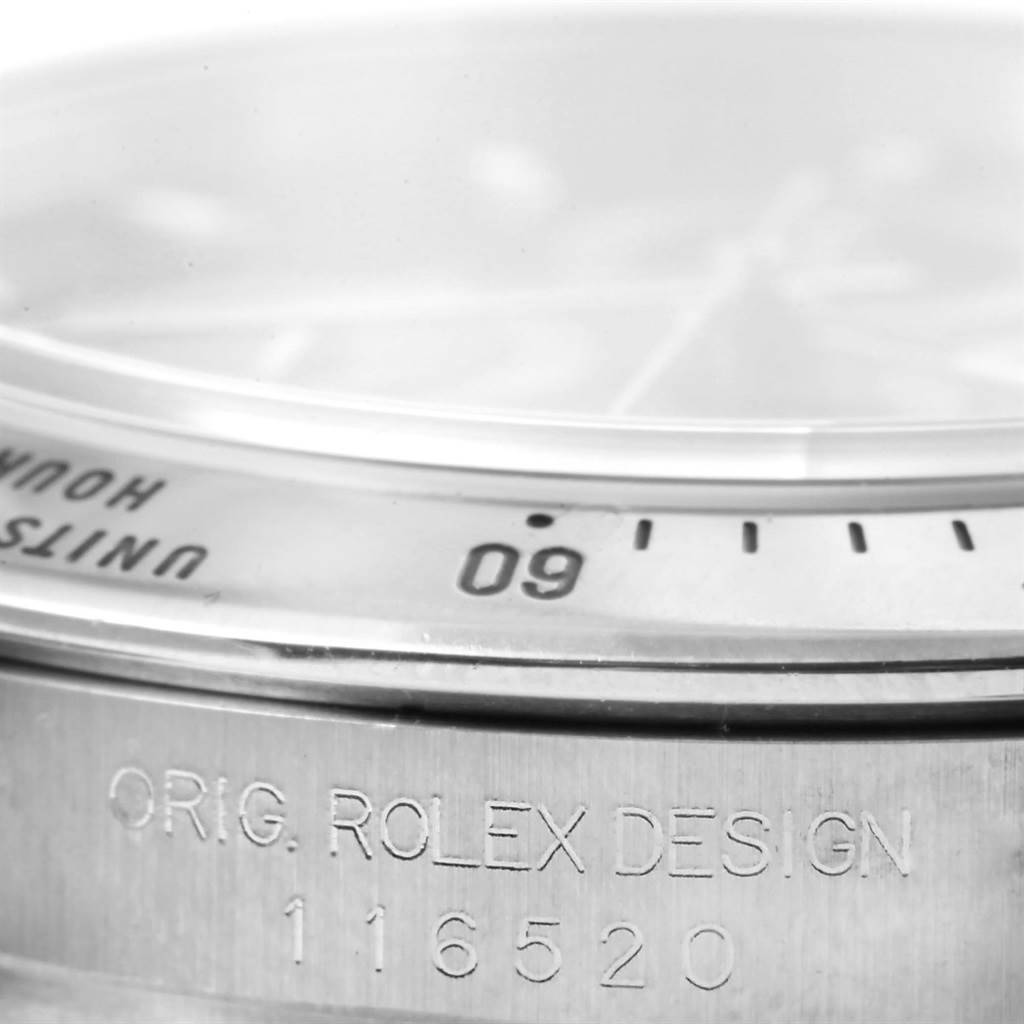 This close-up image shows the bezel and the inscribed side of a Rolex Daytona 116520 Men's Stainless Steel Black Dial 116520 Men's Stainless Steel Black Dial watch, highlighting the design details and model number.