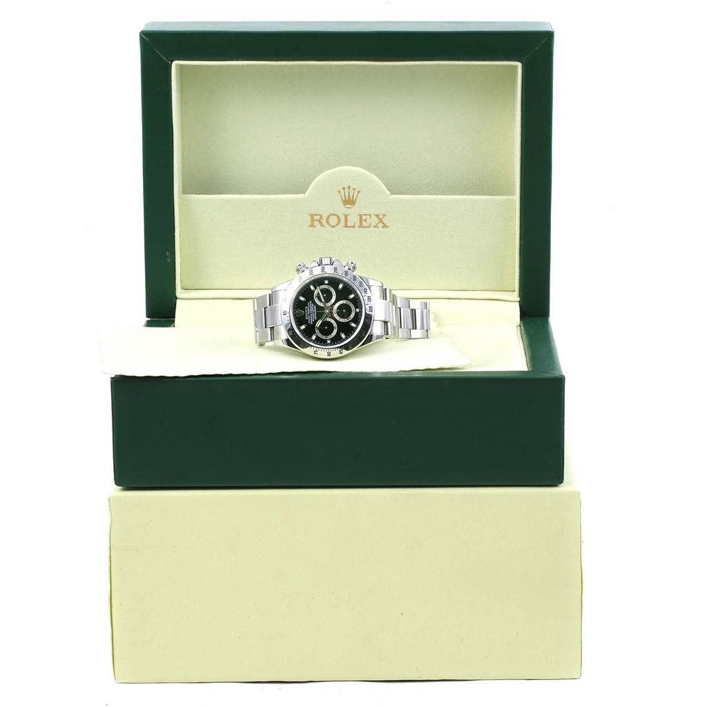 The Rolex Daytona 116520 Men's Stainless Steel Black Dial 116520 Men's Stainless Steel Black Dial watch is shown from a front angle, placed inside its green box.