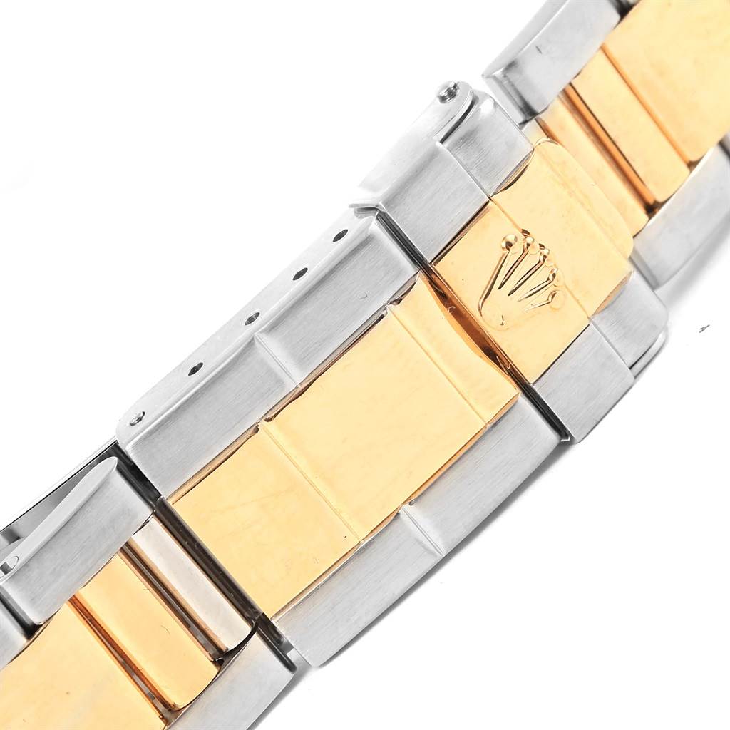 This image shows a close-up angle of the bracelet clasp of the Rolex Daytona 16523 Men's Steel and Gold (two tone) Black Dial 16523 Men's Steel and Gold (two tone) Black Dial watch, highlighting the two-tone metal finish and crown logo.