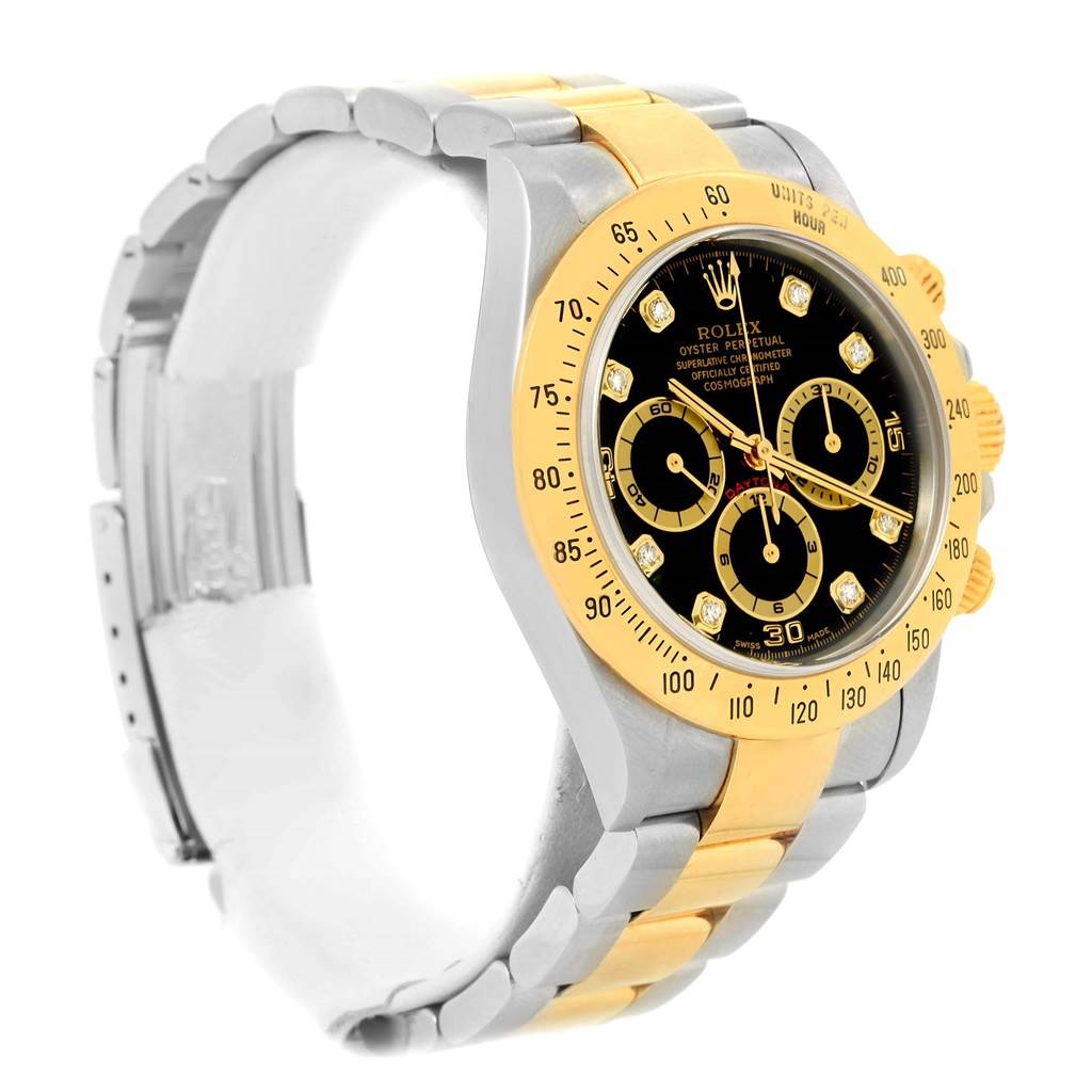 The Rolex Daytona 16523 Men's Steel and Gold (two tone) Black Dial 16523 Men's Steel and Gold (two tone) Black Dial watch is shown at an angled side view, highlighting the black dial, gold bezel, and two-tone bracelet.
