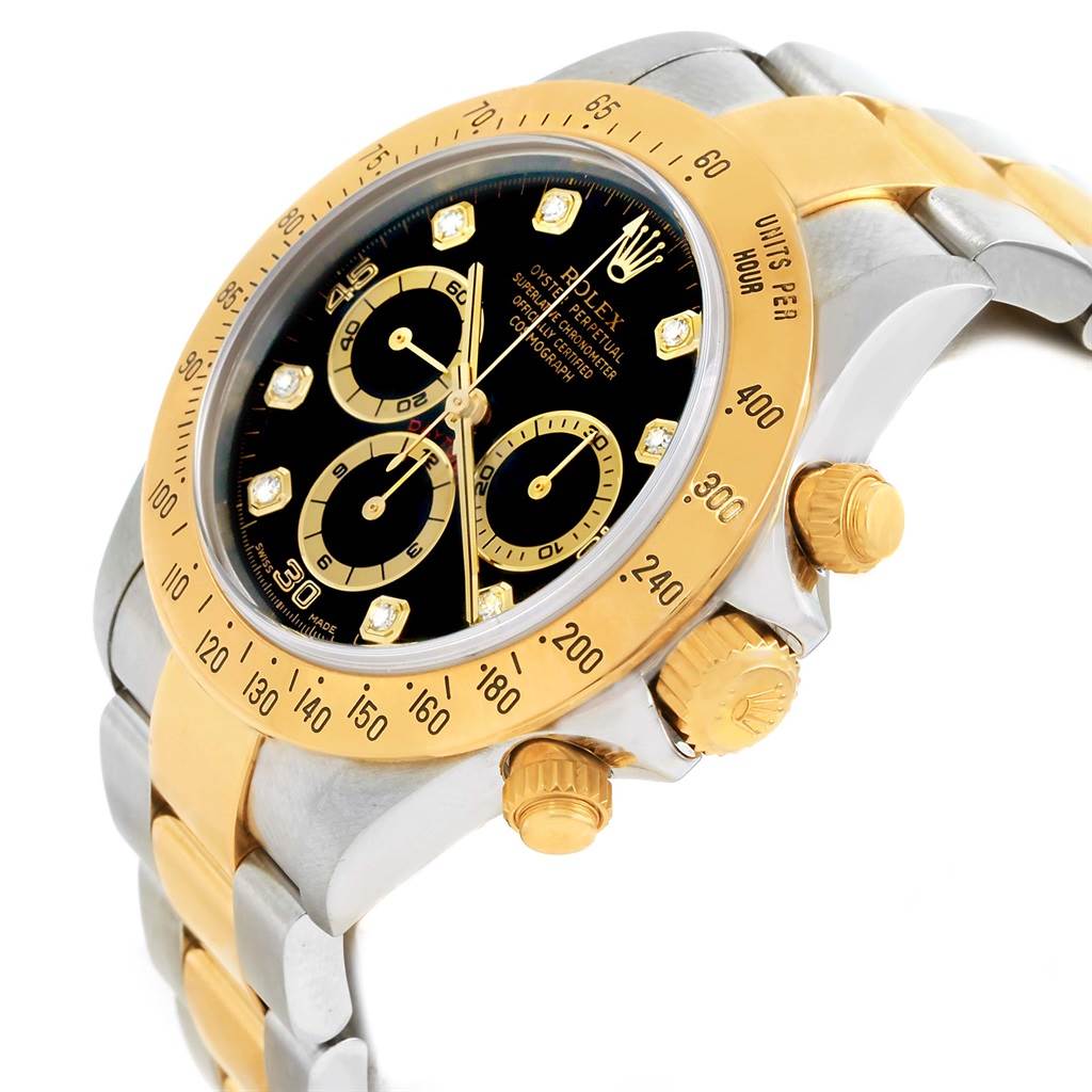 This side-angle image of the Rolex Daytona 16523 Men's Steel and Gold (two tone) Black Dial 16523 Men's Steel and Gold (two tone) Black Dial watch shows the dial, bezel, and crown with pushers.