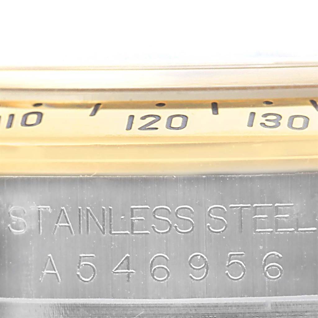 Close-up of the bezel and case of a Rolex Daytona 16523 Men's Steel and Gold (two tone) Black Dial 16523 Men's Steel and Gold (two tone) Black Dial watch, showing the engraved serial number and part of the tachymeter scale.