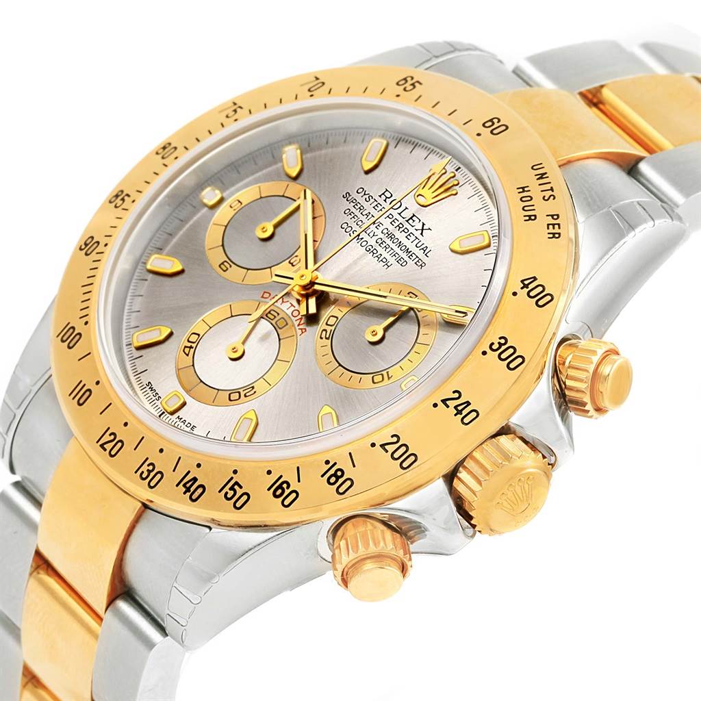 This image shows a close-up of the Rolex Daytona 116523 Men's Steel and Gold (two tone) Grey Dial 116523 Men's Steel and Gold (two tone) Grey Dial watch, highlighting its dial, bezel, and side buttons.