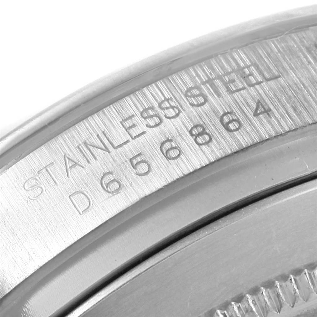 The image shows a close-up of the case back edge and serial number of a Rolex Daytona 116520 Men
s Stainless Steel White Dial 116520 Men
s Stainless Steel White Dial watch.