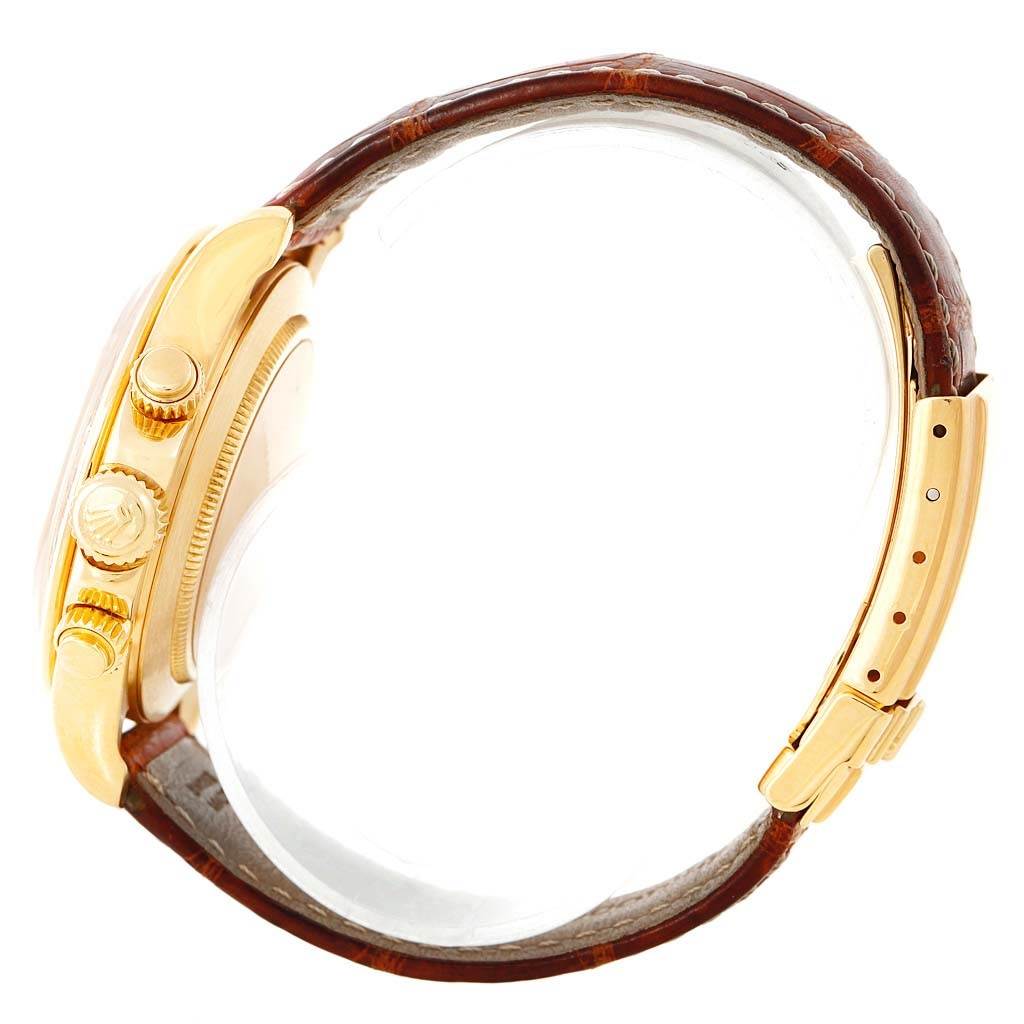 The image shows a side view of a gold Rolex Daytona 16518 Men's Yellow Gold White Dial 16518 Men's Yellow Gold White Dial watch, highlighting the crown, pushers, and leather strap with clasp.