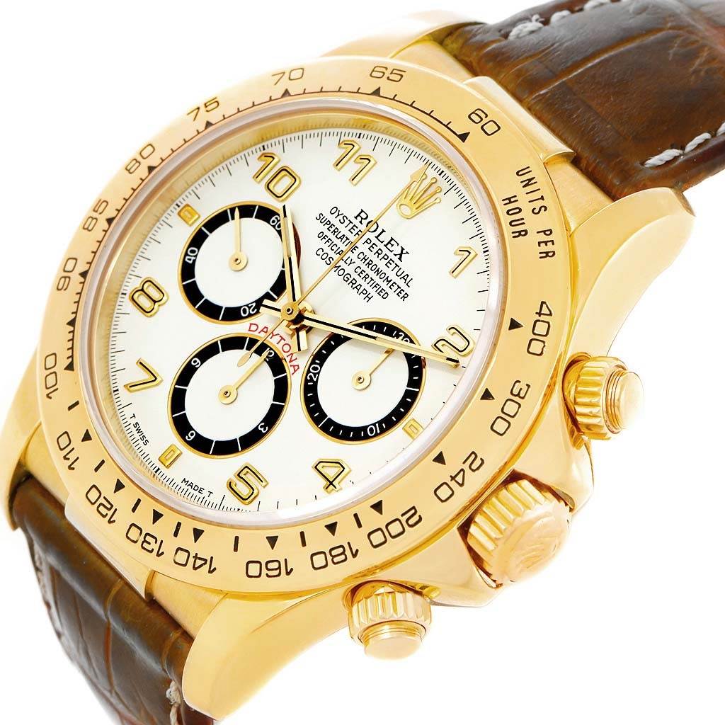 This image shows a Rolex Daytona 16518 Men's Yellow Gold White Dial 16518 Men's Yellow Gold White Dial watch from an oblique angle, highlighting the face, bezel, chronograph dials, crown, and leather strap.