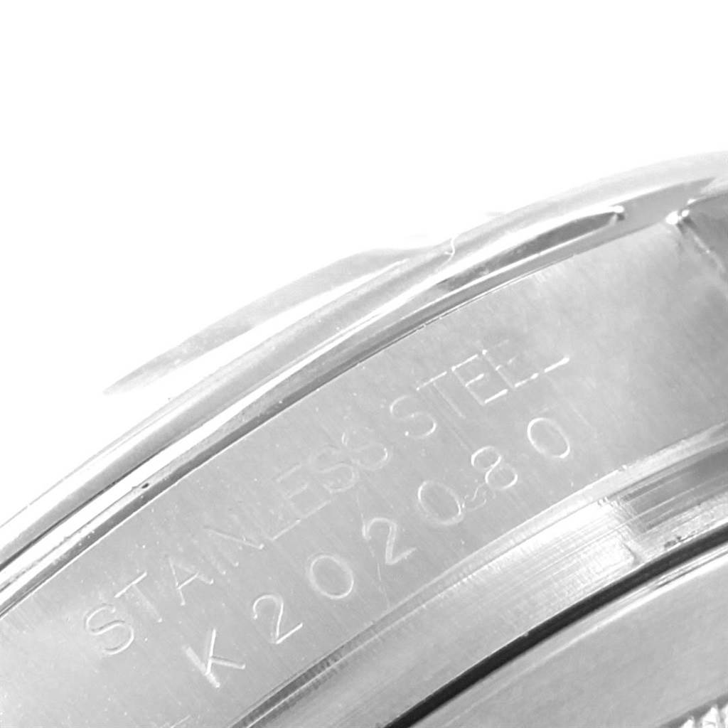 The image shows a close-up of the case side and engraved serial number of a Rolex Daytona 116520 Men's Stainless Steel White Dial 116520 Men's Stainless Steel White Dial watch, featuring a stainless steel material.