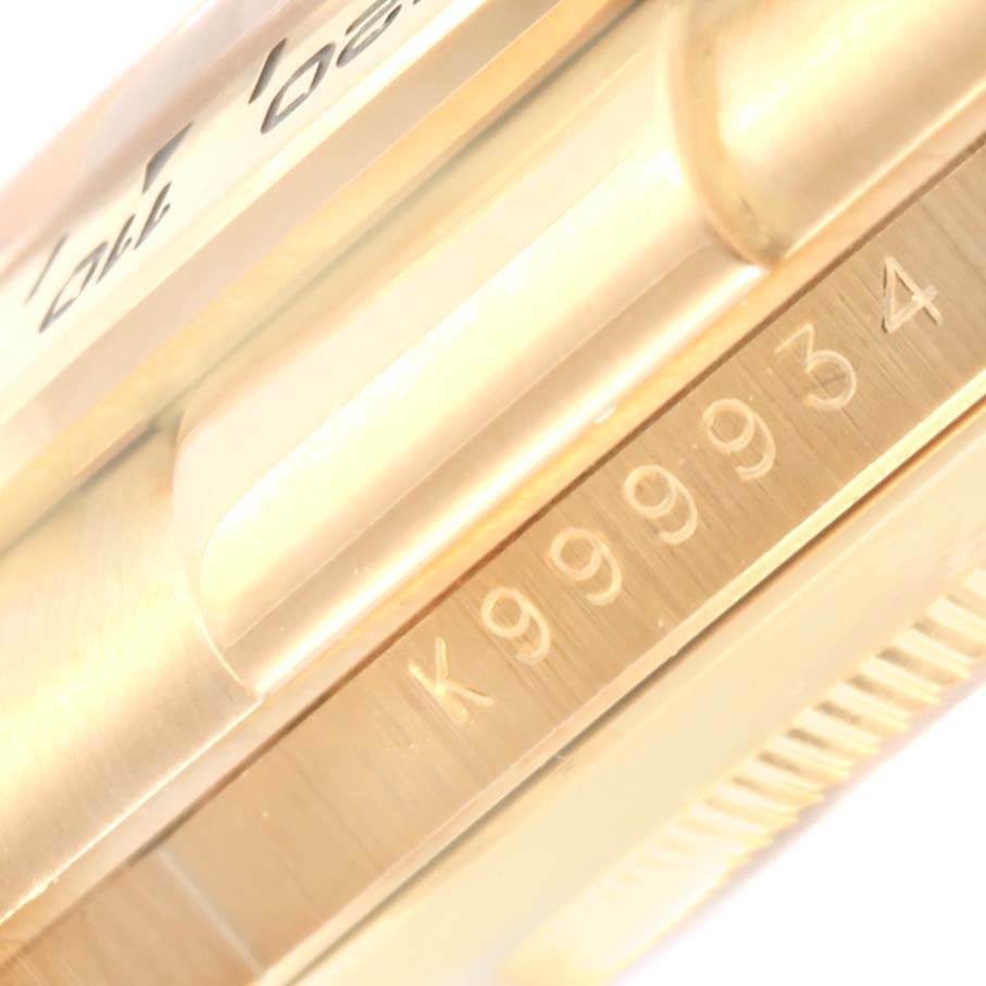 The image shows a close-up of the side of a Rolex Daytona 116518 Men's Yellow Gold White Dial 116518 Men's Yellow Gold White Dial watch, highlighting its serial number engraving.