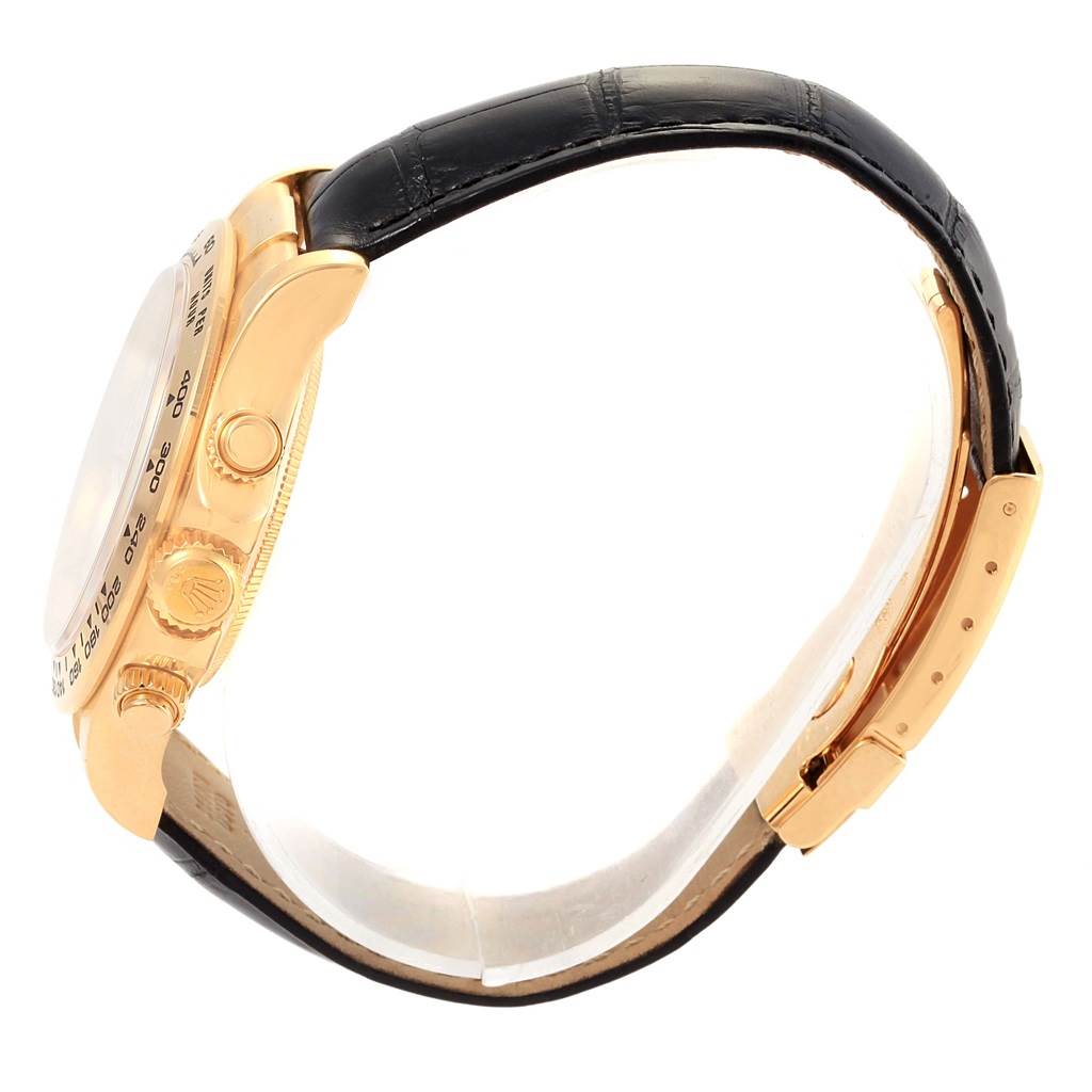 This Rolex Daytona 116518 Men's Yellow Gold White Dial 116518 Men's Yellow Gold White Dial watch is shown from a side angle, highlighting the case, crown, pushers, and leather strap with a clasp.