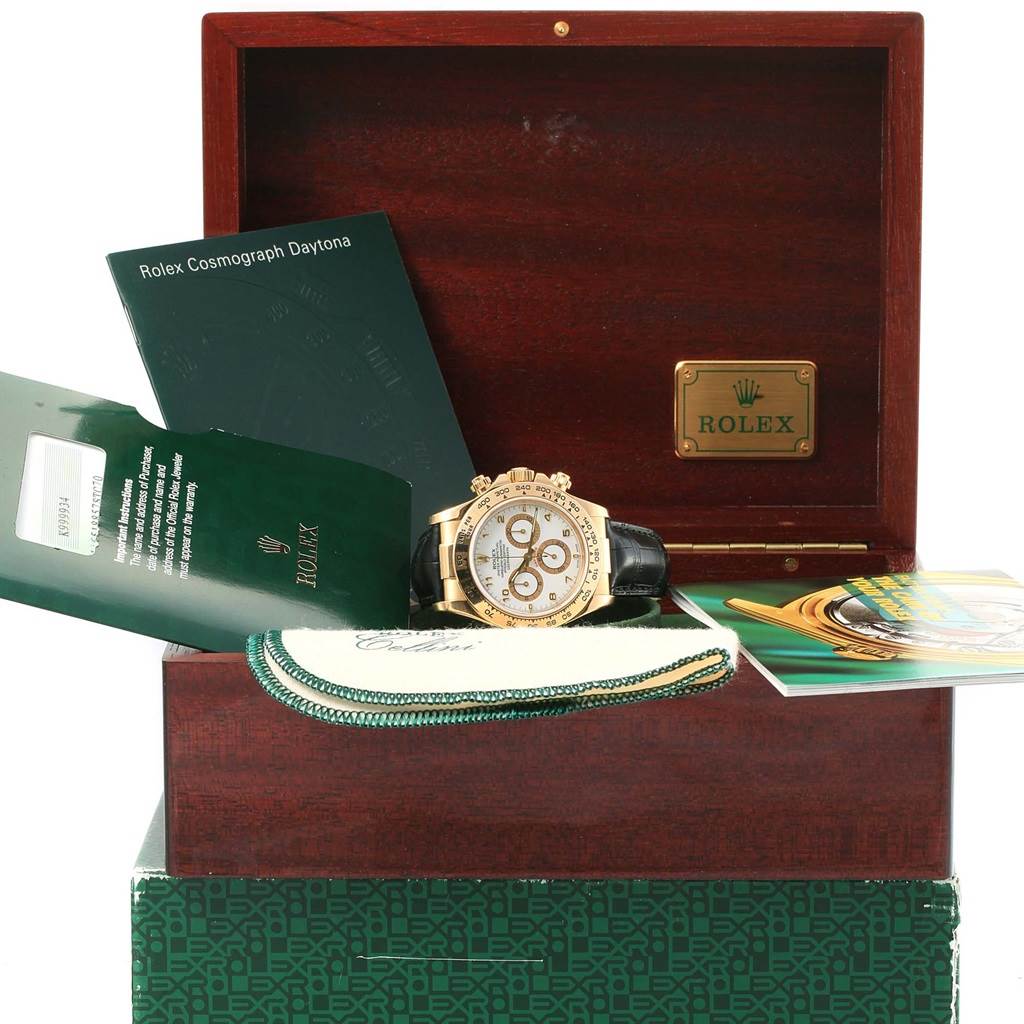 The image shows a Rolex Daytona 116518 Men's Yellow Gold White Dial 116518 Men's Yellow Gold White Dial watch, its wooden box, booklets, and accessories from a front angle.
