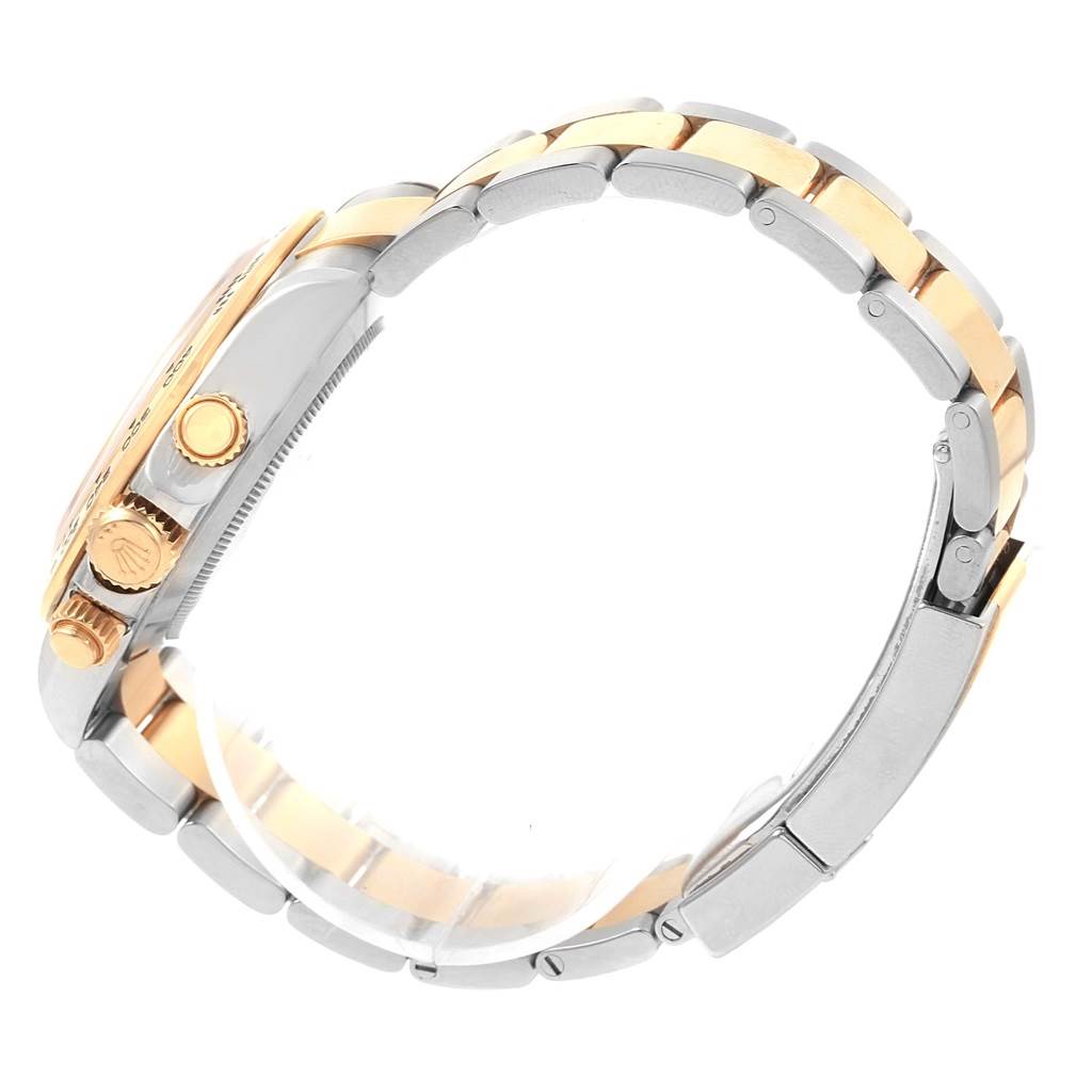 This side view of a Rolex Daytona 116503 Men's Steel and Gold (two tone) White Dial 116503 Men's Steel and Gold (two tone) White Dial watch shows the bracelet, case, and crown.