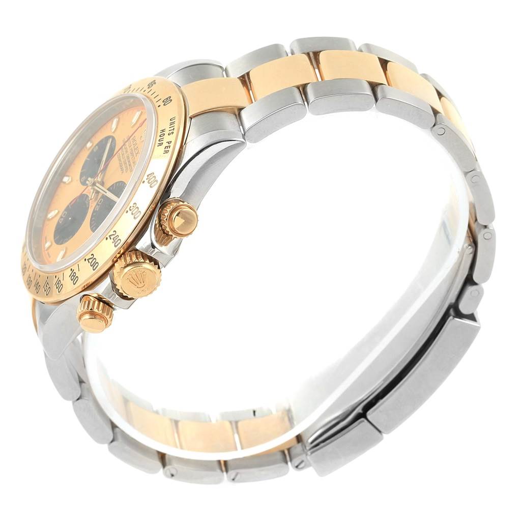 The image shows a side view of the Rolex Daytona 116523 Men's Steel and Gold (two tone) Champagne Dial 116523 Men's Steel and Gold (two tone) Champagne Dial, focusing on its crown, pushers, and two-tone bracelet.