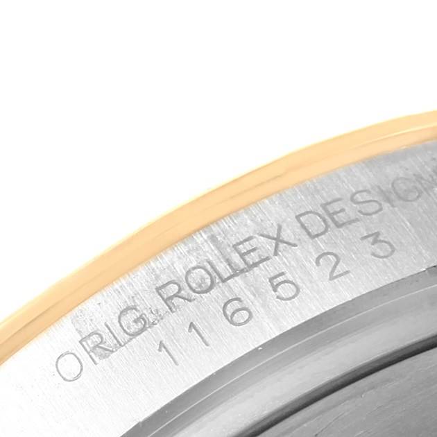 This close-up of the Rolex Daytona 116523 Men's Steel and Gold (two tone) Champagne Dial 116523 Men's Steel and Gold (two tone) Champagne Dial watch shows the engraved model number on the inner bezel.