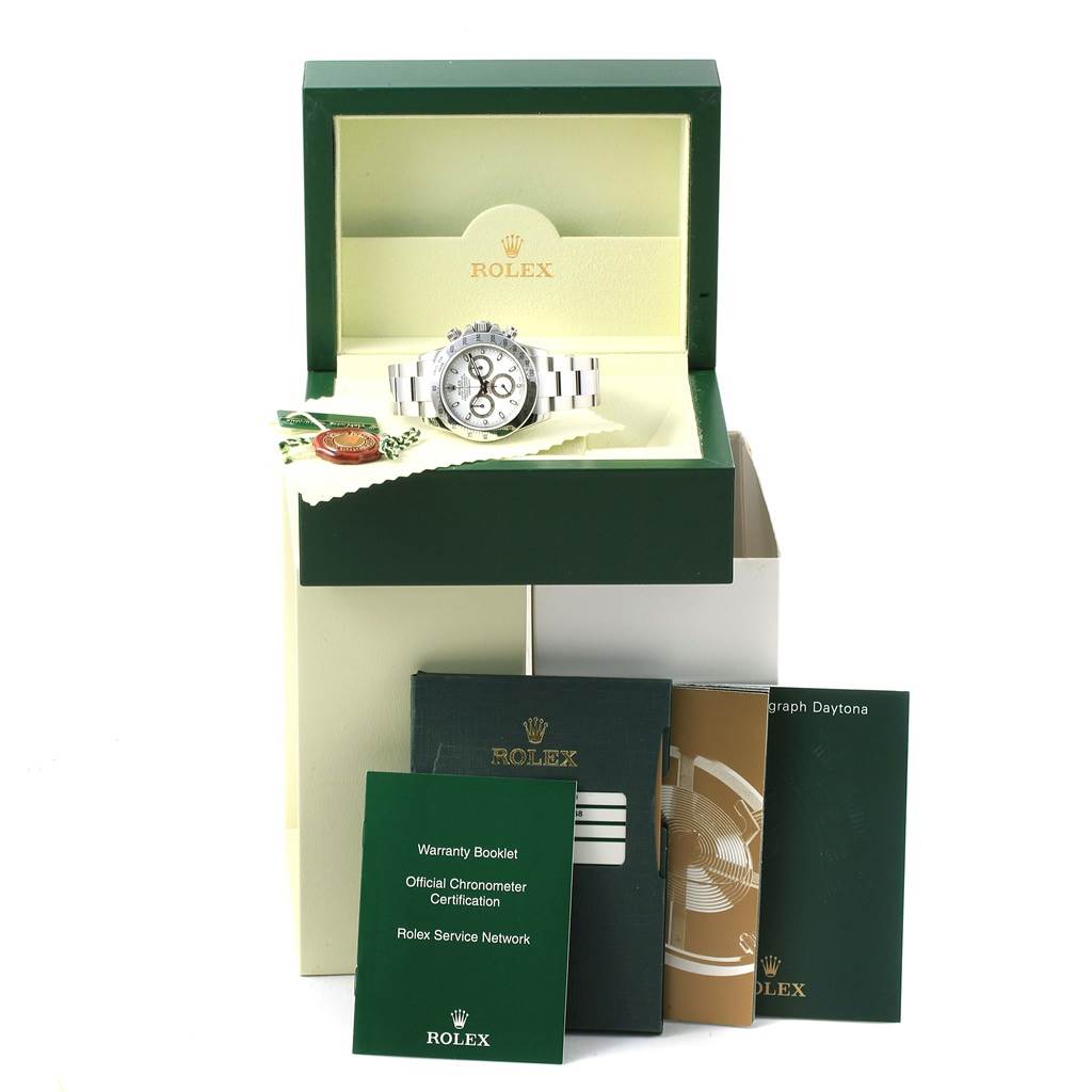 The image shows a Rolex Daytona 116520 Men's Stainless Steel White Dial 116520 Men's Stainless Steel White Dial watch at a front angle along with its box, warranty booklet, official chronometer certification, and service booklets.