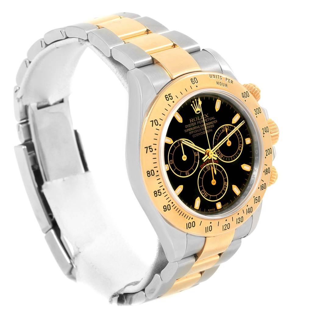 This image shows a side and partial top view of a Rolex Daytona 116523 Men's Steel and Gold (two tone) Black Dial 116523 Men's Steel and Gold (two tone) Black Dial watch, highlighting its gold and silver bracelet and black dial.