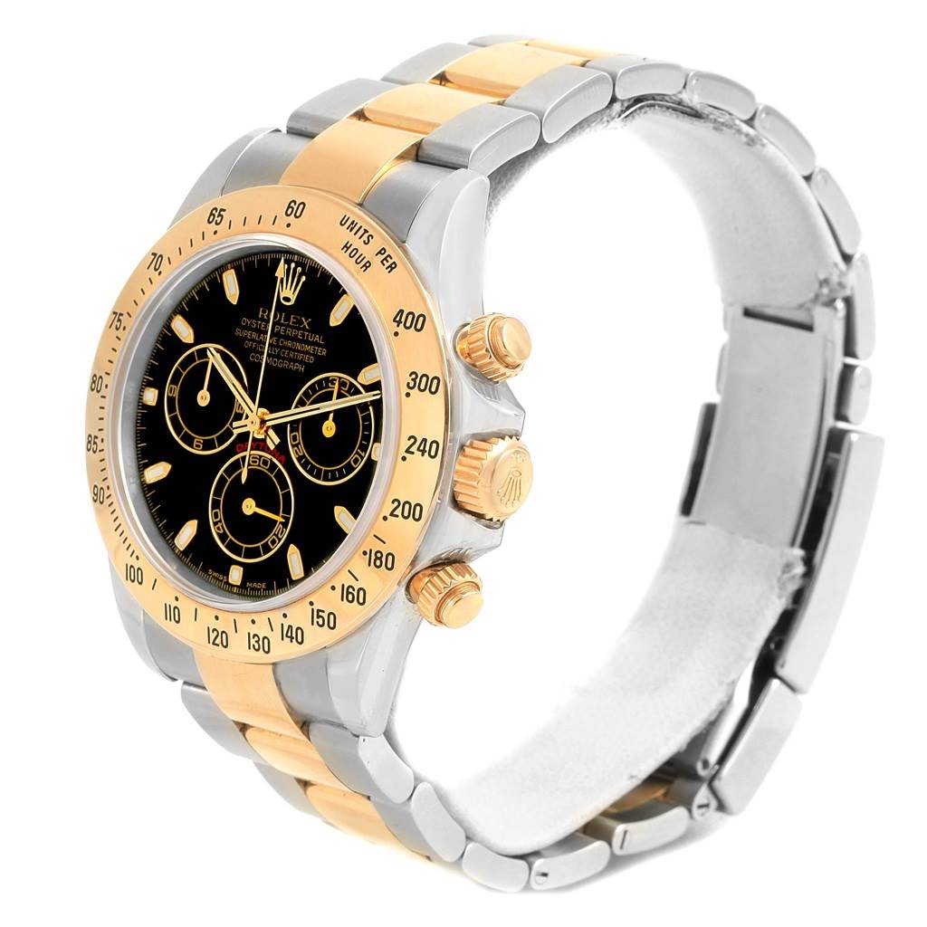 The image shows a Rolex Daytona 116523 Men's Steel and Gold (two tone) Black Dial 116523 Men's Steel and Gold (two tone) Black Dial watch at an angle highlighting its bracelet, bezel, and dial.