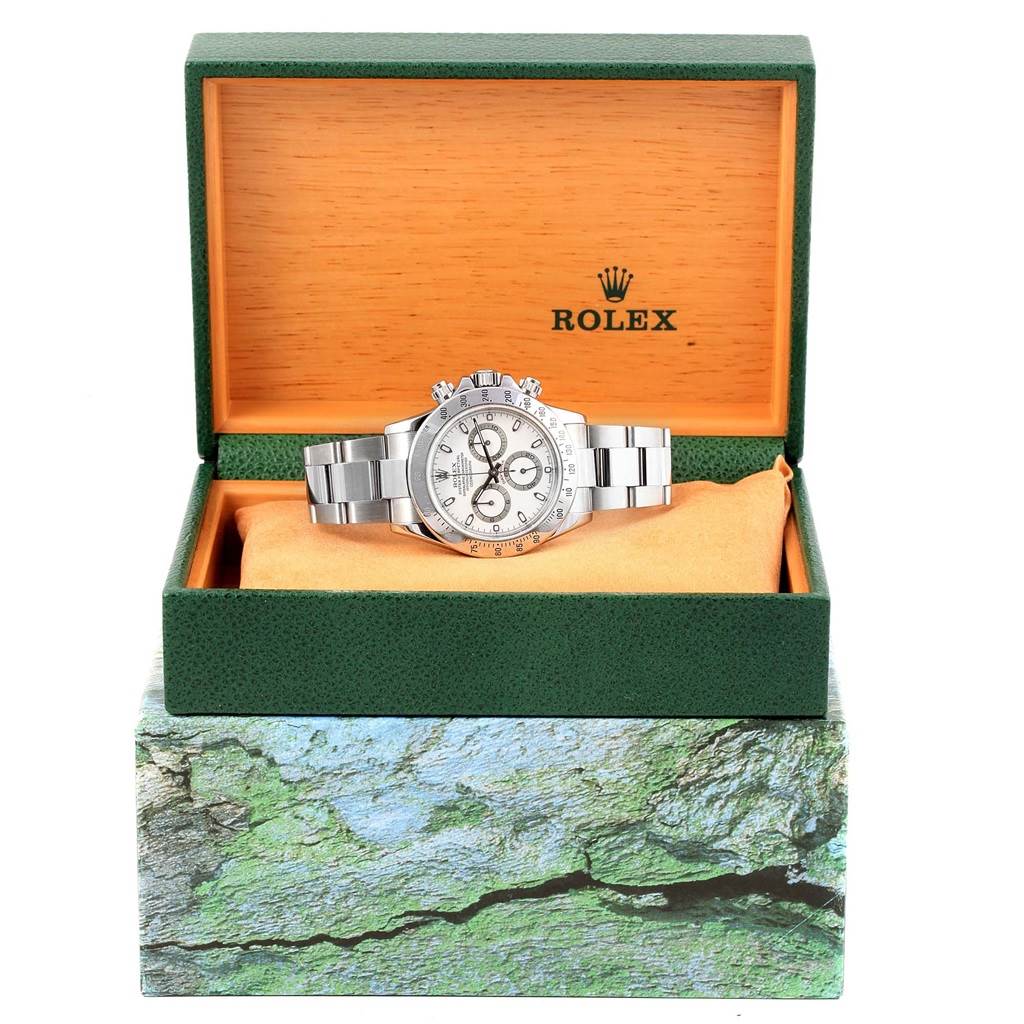 A Rolex Daytona 116520 Men's Stainless Steel White Dial 116520 Men's Stainless Steel White Dial watch displayed in its open green and wooden box, viewed from the front.