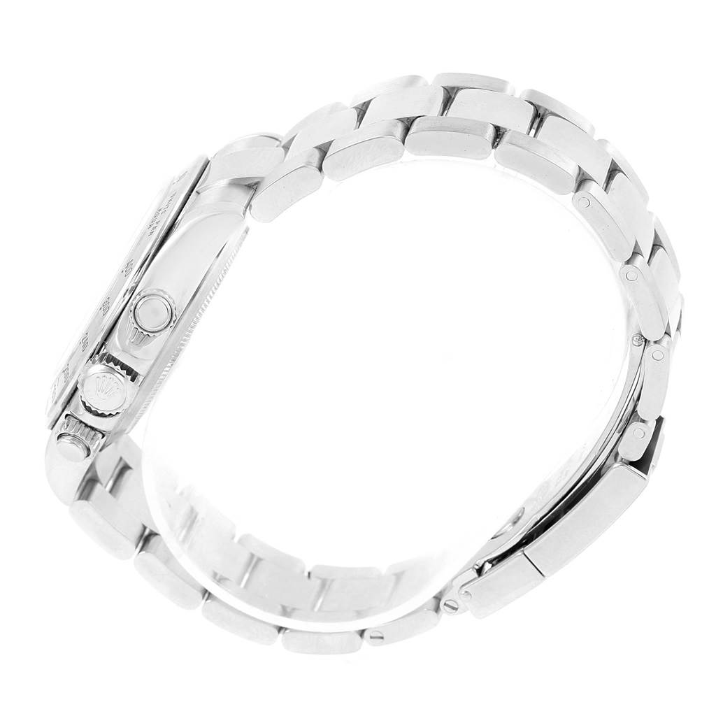 The image shows a side view of the Rolex Daytona 116520 Men's Stainless Steel White Dial 116520 Men's Stainless Steel White Dial's stainless steel bracelet and case with crown and pushers visible.