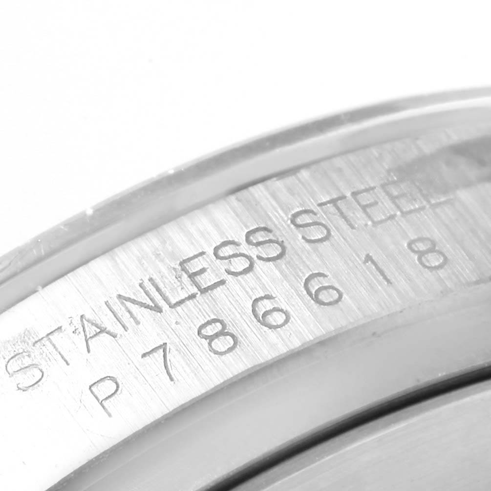 This image shows a close-up of the serial number and "Stainless Steel" engraving on the casing of a Rolex Daytona 116520 Men's Stainless Steel White Dial 116520 Men's Stainless Steel White Dial watch.