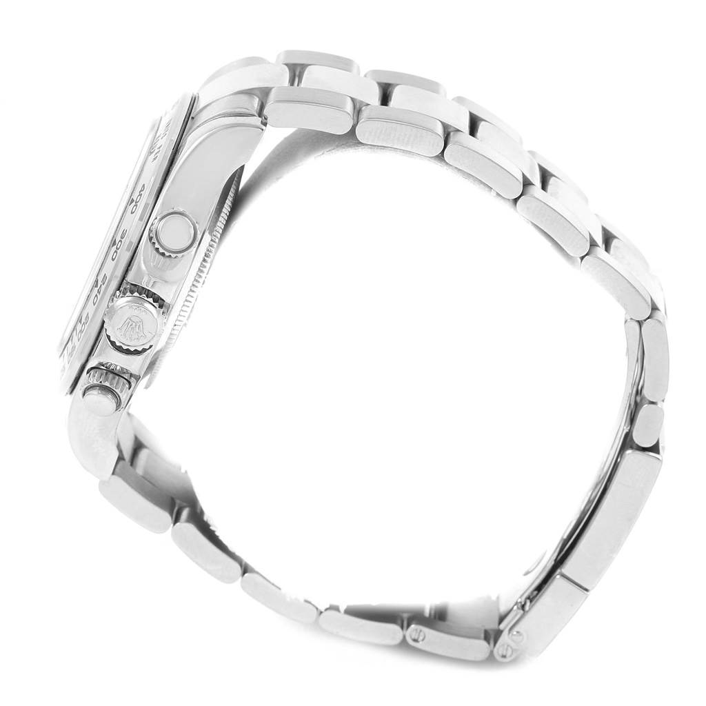 The image shows a side view of a Rolex Daytona 116509 Men's White Gold Blue Dial 116509 Men's White Gold Blue Dial watch, highlighting the crown and pushers, and part of the metal bracelet.