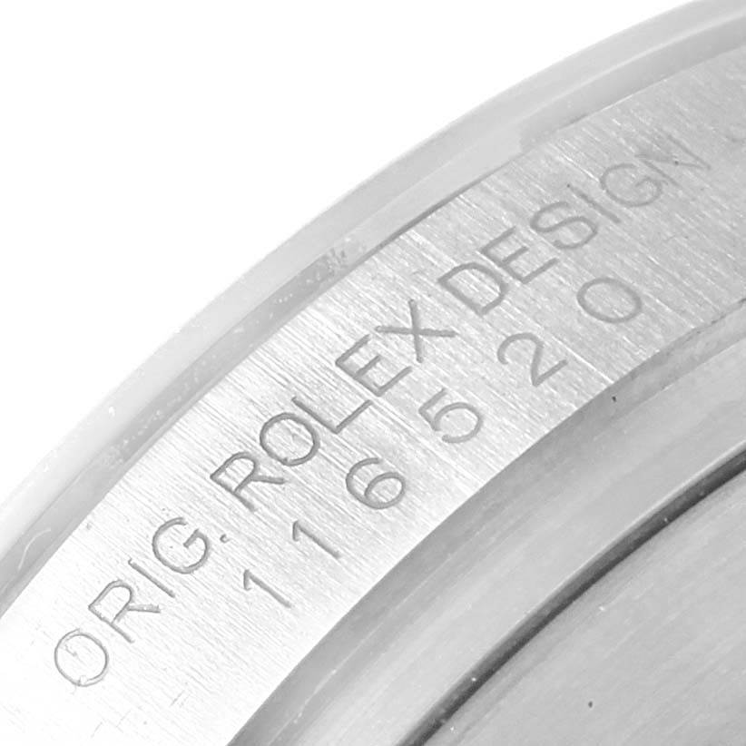 This image shows a close-up angle of the Rolex Daytona 116520 Men's Stainless Steel Black Dial 116520 Men's Stainless Steel Black Dial watch's inner bezel with engraved text.