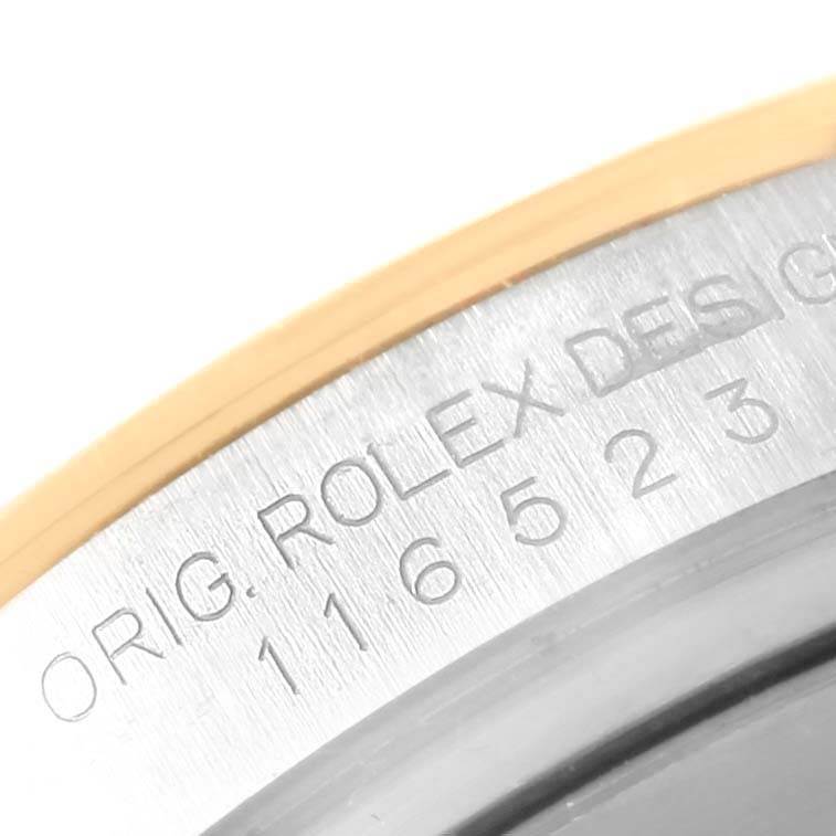 This close-up image shows the engraved model number on the side of the Rolex Daytona 116523 Men's Steel and Gold (two tone) Grey Dial 116523 Men's Steel and Gold (two tone) Grey Dial watch case.