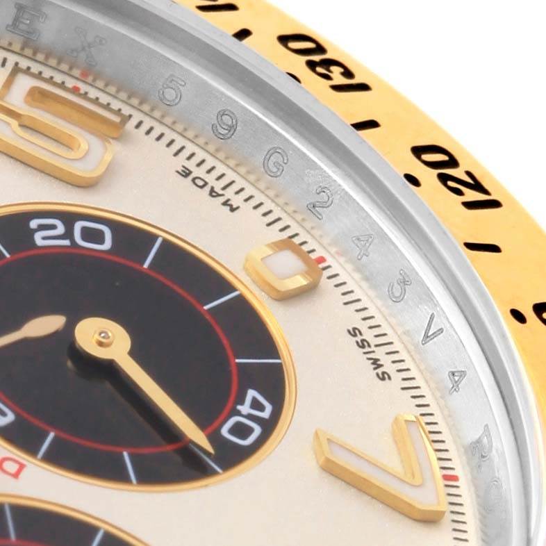 This close-up image of the Rolex Daytona 116523 Men's Steel and Gold (two tone) White Dial 116523 Men's Steel and Gold (two tone) White Dial watch shows its dial, subdial, and part of the bezel with engraved numbers.