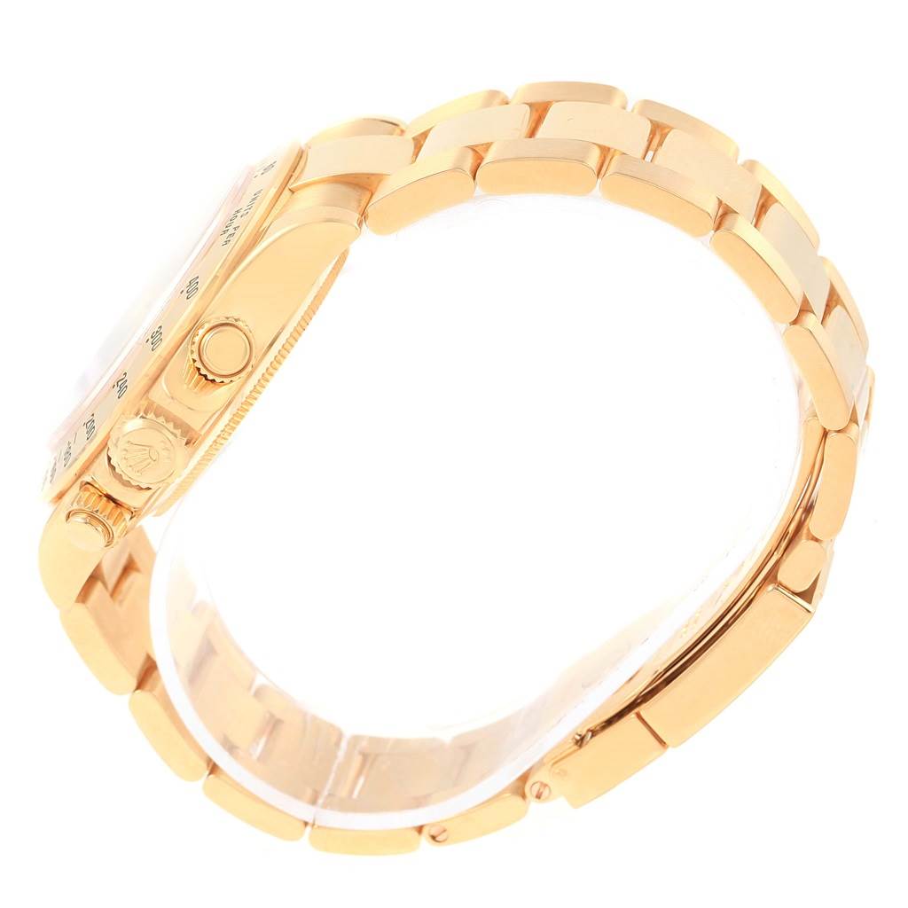 The image shows a side view of a Rolex Daytona 116528 Men's Yellow Gold Champagne Dial 116528 Men's Yellow Gold Champagne Dial watch, highlighting the crown, pushers, and part of the bracelet.