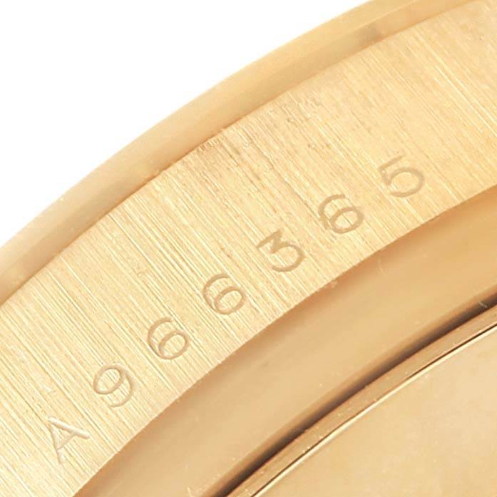 This close-up image shows the bezel of a Rolex Daytona 116528 Men's Yellow Gold Champagne Dial 116528 Men's Yellow Gold Champagne Dial watch, focusing on its engraved numbers.