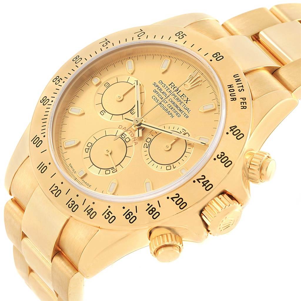 The Rolex Daytona 116528 Men's Yellow Gold Champagne Dial 116528 Men's Yellow Gold Champagne Dial watch is shown at an angled close-up, highlighting its gold chronograph dial, bezel, and bracelet.
