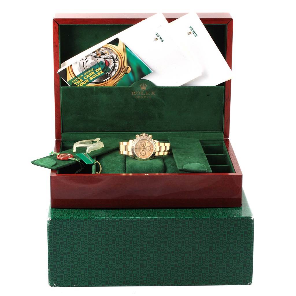 The Rolex Daytona 116528 Men's Yellow Gold Champagne Dial 116528 Men's Yellow Gold Champagne Dial watch is presented in an open luxury box with documentation and accessories.