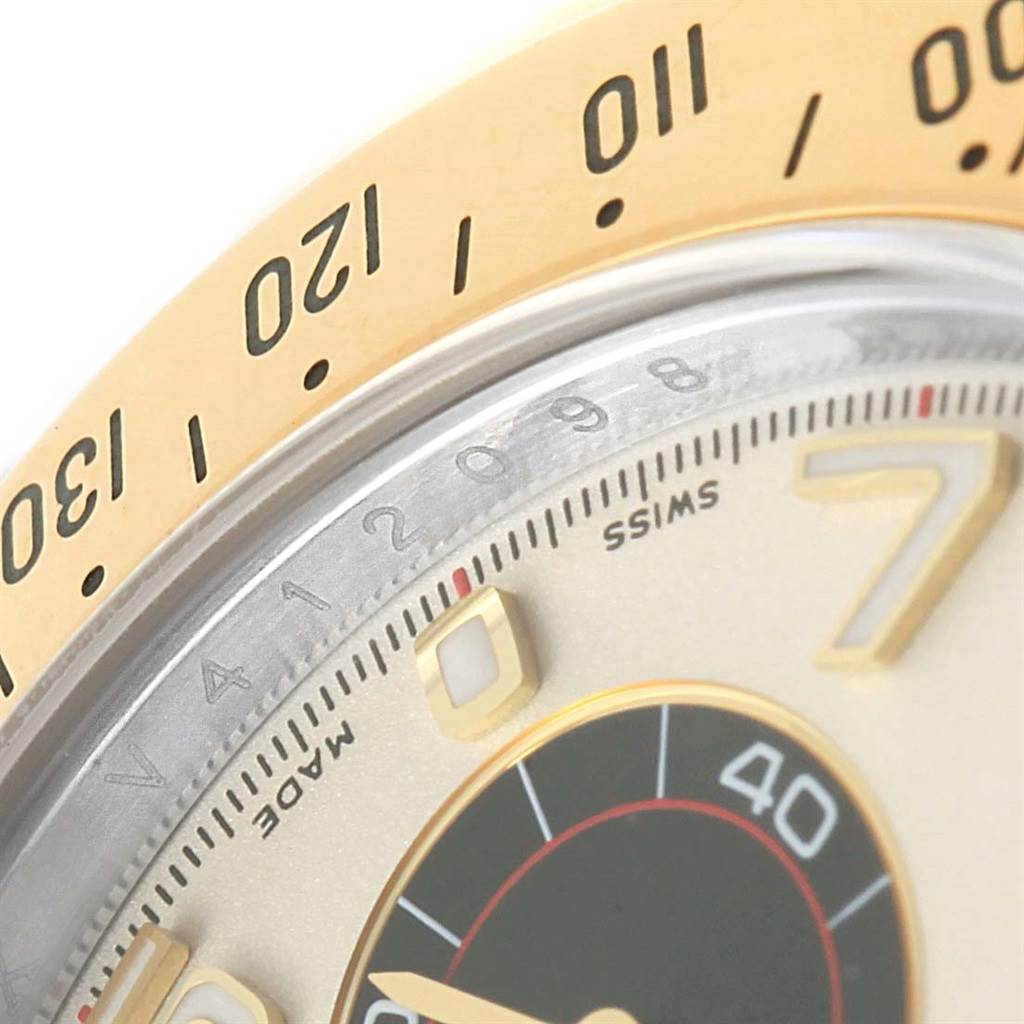 This close-up image shows the bezel and part of the dial, including markings and numeral details of the Rolex Daytona 116523 Men's Steel and Gold (two tone) White Dial 116523 Men's Steel and Gold (two tone) White Dial watch.