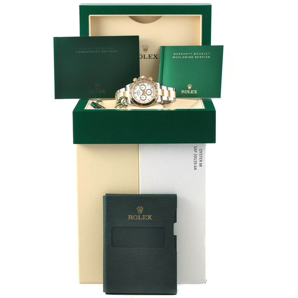 The image shows a Rolex Daytona 116523 Men's Steel and Gold (two tone) White Dial 116523 Men's Steel and Gold (two tone) White Dial watch with its box, warranty booklet, and additional documents viewed from the front.