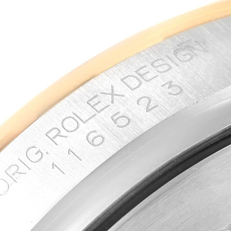 The image shows a close-up of the case back and model engraving of a Rolex Daytona 116523 Men's Steel and Gold (two tone) Grey Dial 116523 Men's Steel and Gold (two tone) Grey Dial watch.